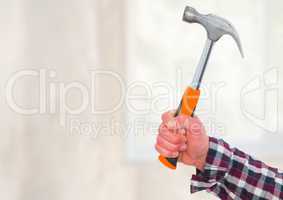 Hand with hammer on building site