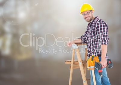 Construction Worker on ladder in front of construction site