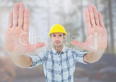 Construction Worker gesturing stop hands in front of construction site