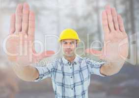 Construction Worker gesturing stop hands in front of construction site