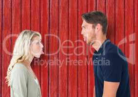 couple funny face each other with red wood background