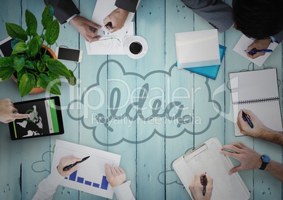 Overhead of business team on blue wood panel with idea doodle