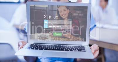 Cropped image of person holding laptop with networking sign up page