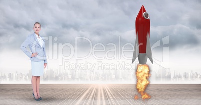 Digital composite image of businesswoman standing by rocket launch against city