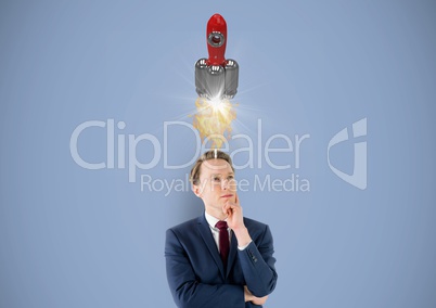 Digital image of thoughtful businessman having rocket launch overhead against blue background