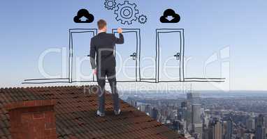 Rear view of businessman drawing doors and gears while standing on roof against sky