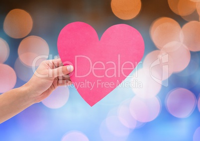 Hand holding heart with sparkling light bokeh background