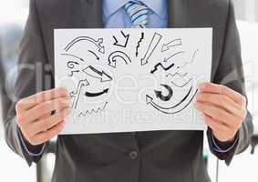 Grey arrow doodles on card held by business man mid section