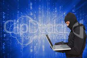 Cyber criminal wearing an hood is hacking a laptop against matrix code background