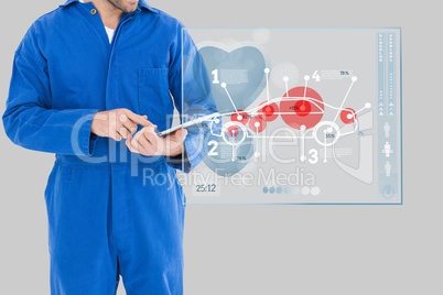 Mechanic using a tablet close to an interface