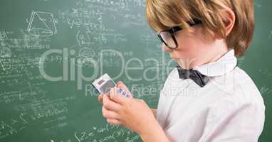 Boy with calculator against green chalkboard with math doodles