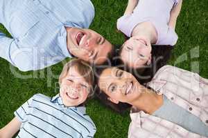 Family lying in the grass