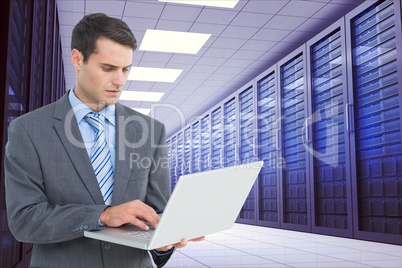 Businessman using a laptop in data center