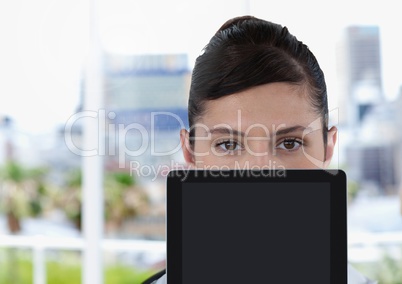 Businesswoman holding tablet in bright office