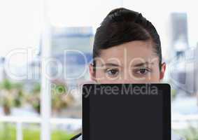 Businesswoman holding tablet in bright office