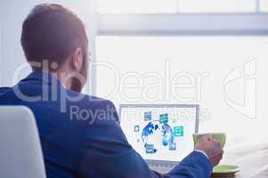 Businessman at desk with laptop and digital icons