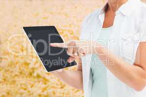 Woman showing her tablet in a field