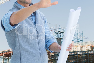 Worker with plans at construction site