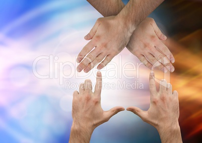 Hands criss crossed with sparkling light bokeh background