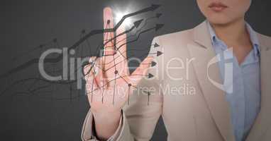 Business woman mid section touching grey graph with flare against grey background