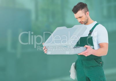 Construction Worker with tool box in front of construction site