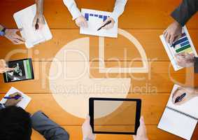 Overhead of business team with orange wood panel and pie chart graph