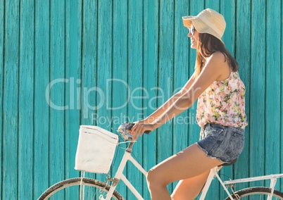 hipster woman on the bike  with light blue wood background