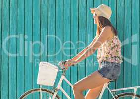 hipster woman on the bike  with light blue wood background
