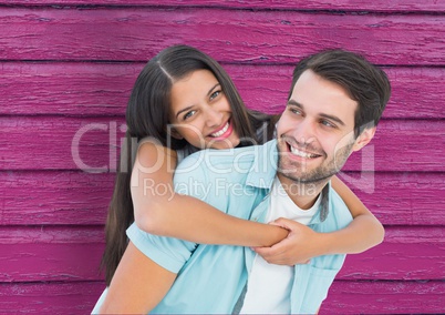 couple laughing  with pink wood background