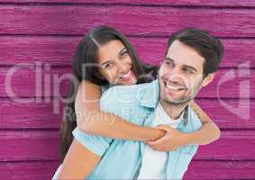 couple laughing  with pink wood background