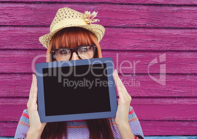 hipster with tablet and hat with pink wood background