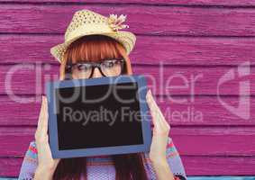 hipster with tablet and hat with pink wood background