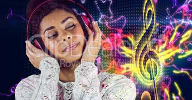 Happy casual woman listenning music with headphones in front of musical note background