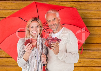couple with umbrella with yellow wood background