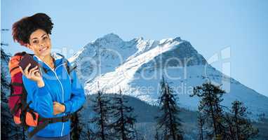 Hipster carrying backpack and diary standing on mountains