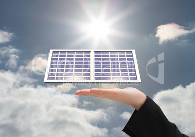 Digital composite image of cropped hand with solar panel against sky during sunny day