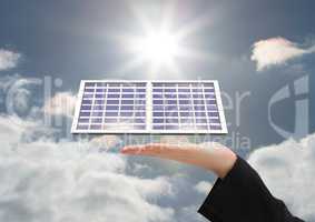 Digital composite image of cropped hand with solar panel against sky during sunny day