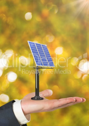 Cropped hand holding solar panel against defocused background