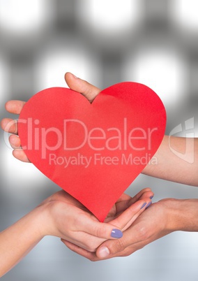 Hands holding heart with sparkling light bokeh background