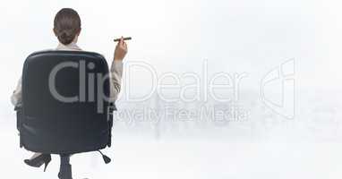 Back of seated business woman smoking cigar and looking at blurry white skyline