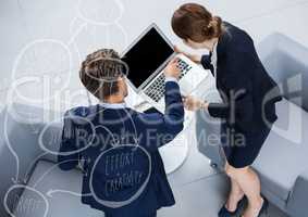 Overhead of business man and woman with laptop behind white brainstorm doodle
