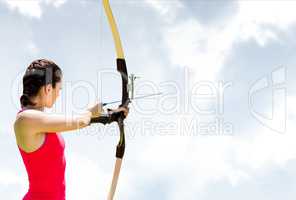 Woman archery against sky