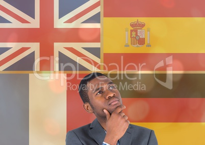 main language flags overlap with gold lights around young man thinking