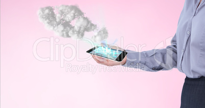Businessman holding a smartphone projecting  holograms against pink background