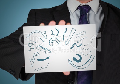 Business man mid section with card showing blue arrow doodles against blue background