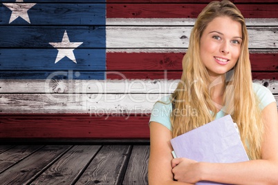 students holding notebook against American flag background