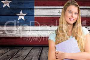 students holding notebook against American flag background