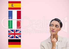 main language flags near young businesswoman. Pink background
