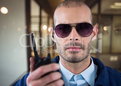 security guard with glasses, headphone and walkie-talkie in the office