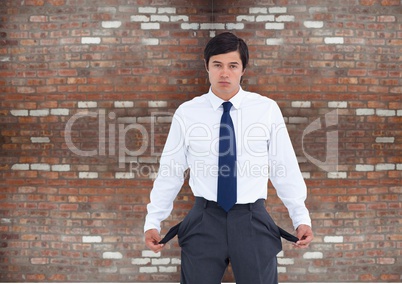 Sad businessman with empty pocket. bricks wall background